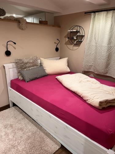 a bedroom with a large bed with purple sheets at kleines Harz-Chalet in Neuwerk