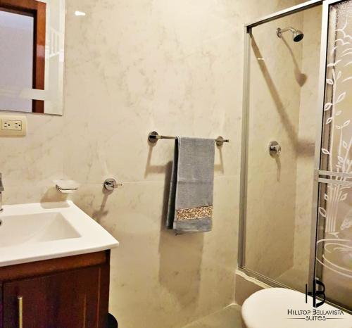 a bathroom with a sink and a shower with a glass door at Hilltop Bellavista, Suite Three, the best choice in Cuenca