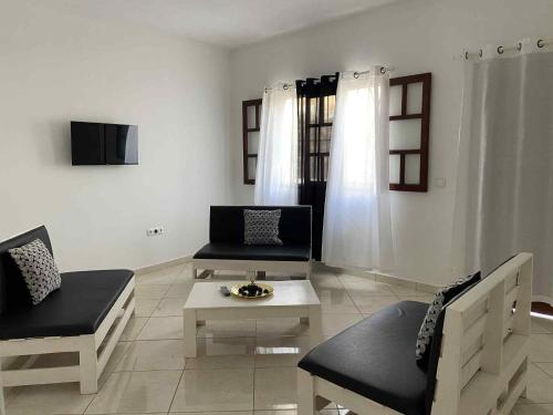 a living room with a couch and a coffee table at MONTROND House in São Filipe