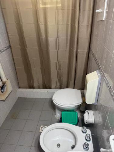 a bathroom with a toilet and a sink at Cabañas Casa Raiz VGB in Villa General Belgrano
