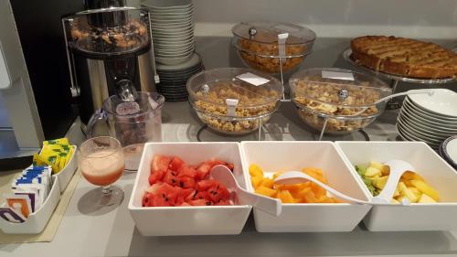a table with bowls of food and glasses of drink at Hotel San Marco BB in Boario Terme