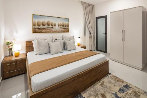 a bedroom with a large bed in a room at Greyasset Amber in Spintex