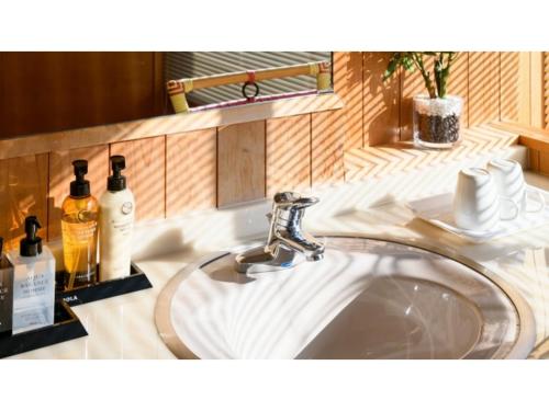 a sink in a bathroom with two bottles of soap at Hotel Symphony - Vacation STAY 48764v in Sagae