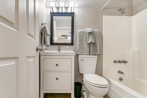 ein Badezimmer mit Toilette, Waschbecken und Spiegel in der Unterkunft Pet-Friendly Raleigh Townhome Near Medical Centers in Asbury