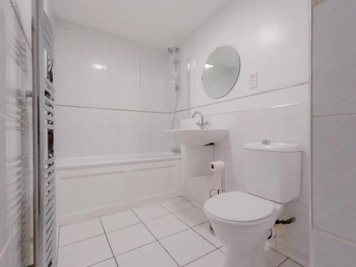 a white bathroom with a toilet and a sink at Stunning 3Bed 2bath family home with Garden in London