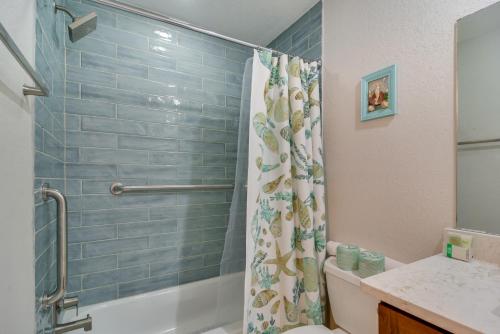 a bathroom with a shower curtain and a toilet at Near Beach! Modern Ground-Floor Condo in St Pete in St Pete Beach