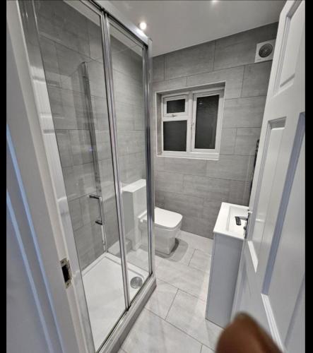 a bathroom with a shower and a toilet at Camden Mia Apa in London