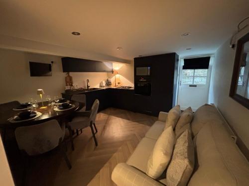 a living room with a couch and a table at Otter Hollow - a spacious central apartment in Middleton