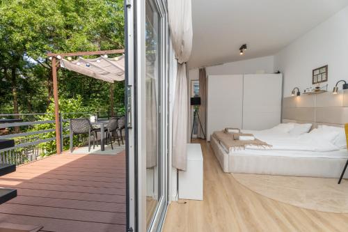 a bedroom with a bed and a balcony at Patrikabin in Tata