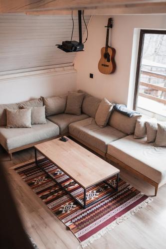 a living room with a couch and a coffee table at Forrest House in Doboj