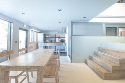a dining room with a wooden table and chairs at Casa CarpeDiem - Vacation STAY 09135v in Ichinomiya