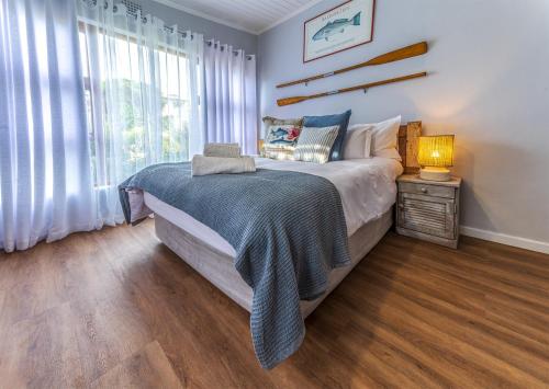 a bedroom with a large bed and a window at Southern Right Guest House in Gansbaai
