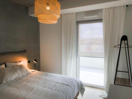Un dormitorio con una cama y una ventana grande en Luxury & Industrial Apartment - Amazing view, en Mulhouse