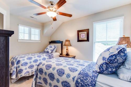 a bedroom with two beds and a ceiling fan at 412A The Inlet House in Virginia Beach