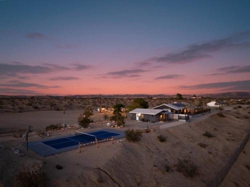 an aerial view of a house with a tennis court at Desert Haven, Pickleball, Stargazing, Spa & Views in Joshua Tree