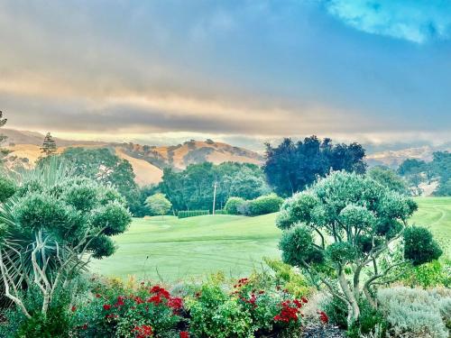 a view of a golf course with trees and flowers at Country Club Living on Golf Course & amazing views in Pleasanton