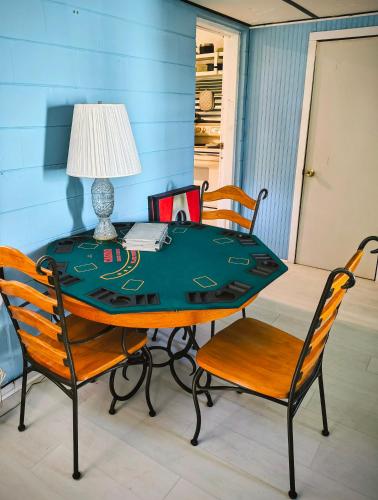 a table with two chairs and a table with a lamp at Spring Street Retreat in St. Augustine