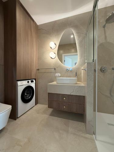 a bathroom with a sink and a washing machine at 4 Seasons Apart in Tomaszów Mazowiecki