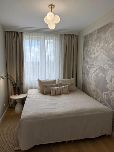 a bedroom with a large bed with a large window at 4 Seasons Apart in Tomaszów Mazowiecki