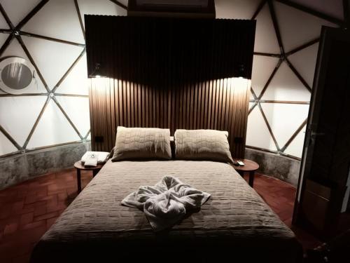 a bedroom with a bed in a room with large windows at Alma Glamping in Xalapa