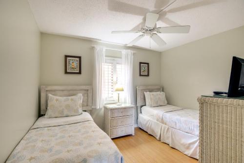 a bedroom with two beds and a ceiling fan at Steps to Beach St Augustine Extended Stay Condo! in Coquina Gables