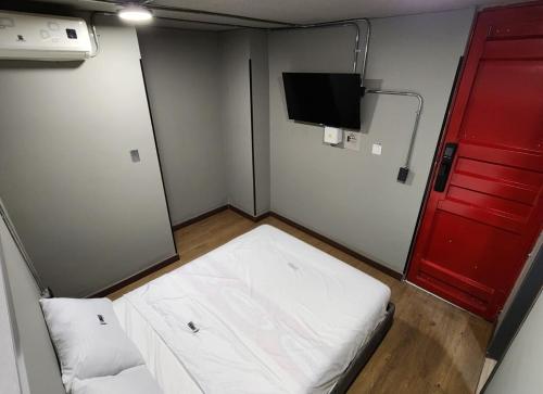 En eller flere senge i et værelse på Eureka Living