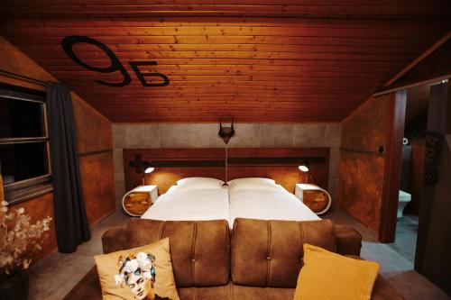 a bedroom with a large bed and a couch at Pepin Stay in Topoľčany