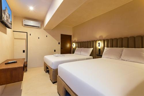 เตียงในห้องที่ Hotel Pakal 58 Centro