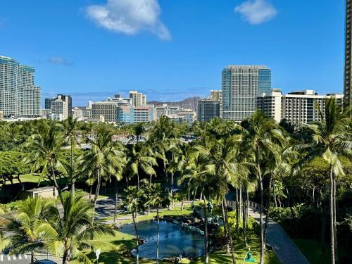 a view of a city with palm trees and a pool at Palms at Waikiki in Honolulu