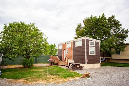 a tiny house with a picnic table and a patio at JW Grand Junction in Grand Junction