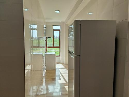 a refrigerator in a room with a window at Apartment chakira family only in Tangier