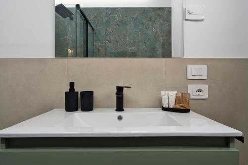 a sink in a bathroom with a mirror at Margherita Luxury Resort near Venice in Santo Stino di Livenza