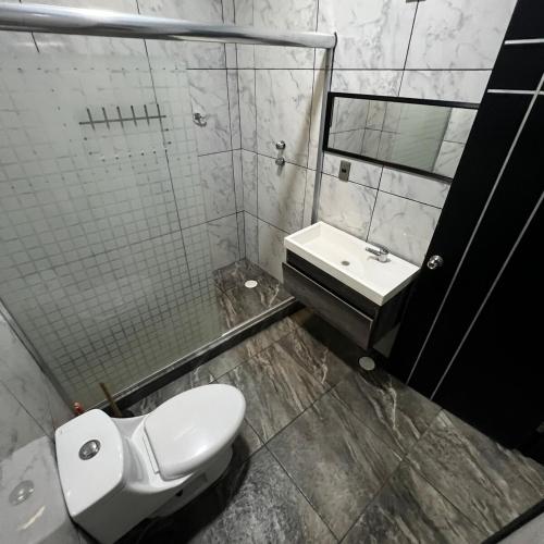 a bathroom with a toilet and a sink at Casa con alberca en Morelos in Barranca Honda