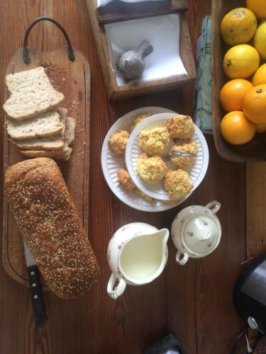 a table with a plate of bread and a plate of food at Casa Viva Hotel Boutique in Junín