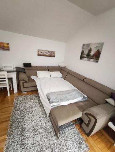 a living room with a couch and a bed at Apartman NN Trebinje in Trebinje