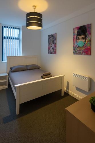 a bedroom with a bed with a mask on it at LT 3 - 1 Bed Apartment - Free Street Parking in Leicester