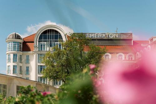 a building with a sign on the top of it at Sheraton Sopot Hotel in Sopot