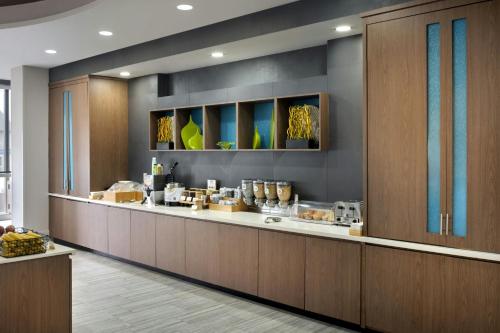 a restaurant with a counter with food on it at SpringHill Suites by Marriott Wichita Airport in Wichita