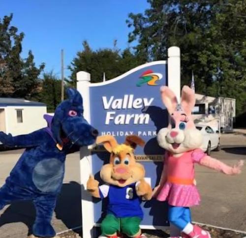two mascots are standing in front of a sign at Coastal Retreats in Great Clacton