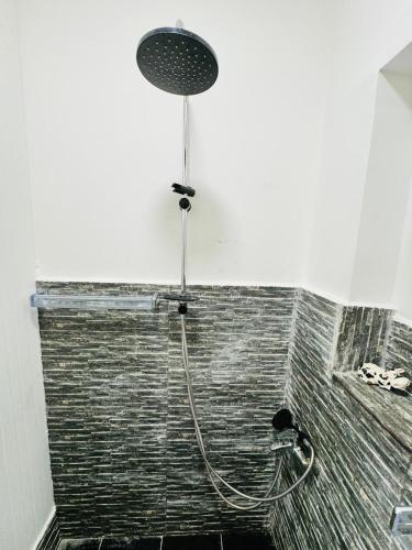 a shower with a shower head in a bathroom at Center House Rabat in Rabat