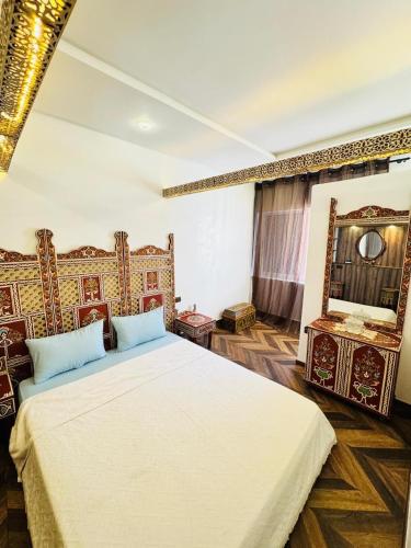 a bedroom with two beds and a mirror at Center House Rabat in Rabat