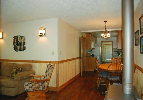 a kitchen and living room with a table and a couch at Ox Yoke in North Wawona
