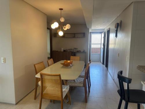 una sala da pranzo e una cucina con tavolo e sedie di Apto no Porto das Dunas - Scopa Beach ad Aquiraz