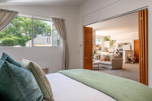 a bedroom with a bed and a living room at The Malibu Retreat Apartments in Malibu Beach