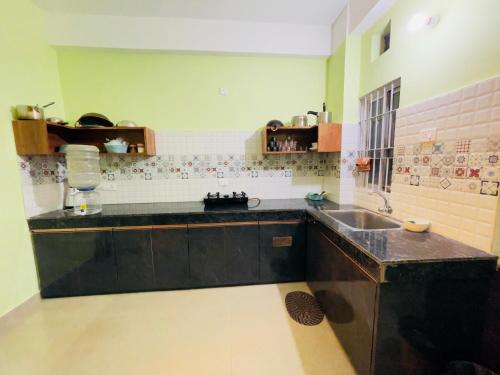 a kitchen with a sink and a counter top at Urban Aura 3bhk near Gs road in Guwahati