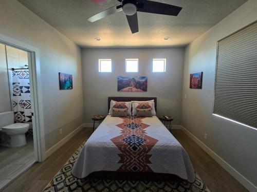 a bedroom with a bed and a ceiling fan at Canyon Casita Near Pages Natural Wonders in Page