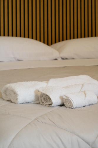 two white towels sitting on top of two beds at Atmosfere 19 in Sant'Egidio del Monte Albino