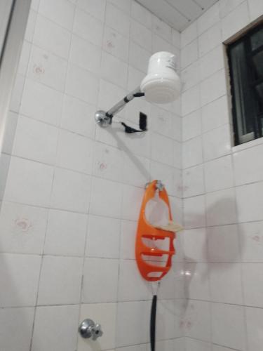 a shower with an orange object on the wall at Aluguel 500,00 a diária in Belém