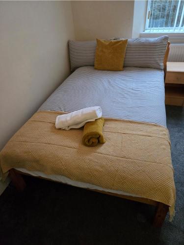 a bed with a teddy bear sitting on top of it at Heart of Aberdeen in Aberdeen