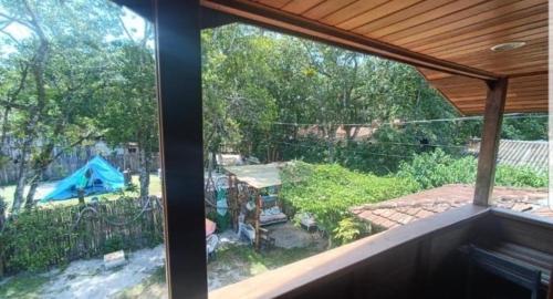 a view of a backyard from a window of a house at Brayan`s House in Ilha do Mel